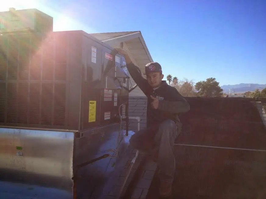 HVAC technician performing Boiler Repair on a rooftop unit in Waldorf